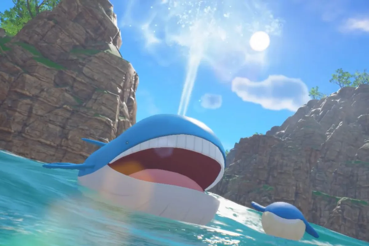 Capture promotionnelle de Pokémon Winds et Waves montrant Wailord et Wailmer à la surface de l'océan près de falaises.